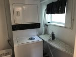 Downstairs Laundry Area with a Stackable Washer and Dryer